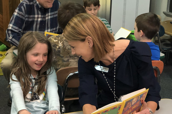 Dr. Hammack reading to student